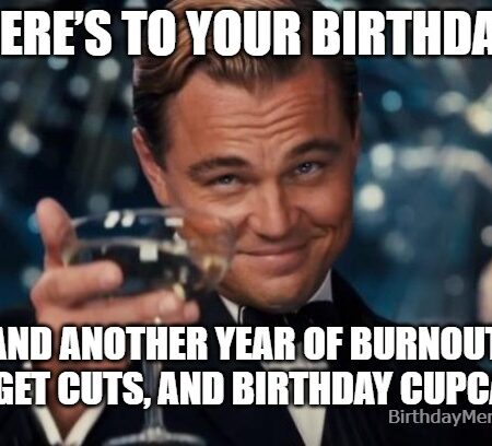Leonardo DiCaprio giving a sarcastic toast with a paper cup in an office birthday setting.